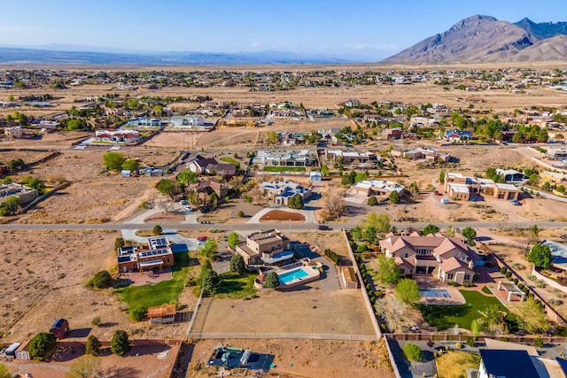 aerial view featuring a desert view and a mountain view