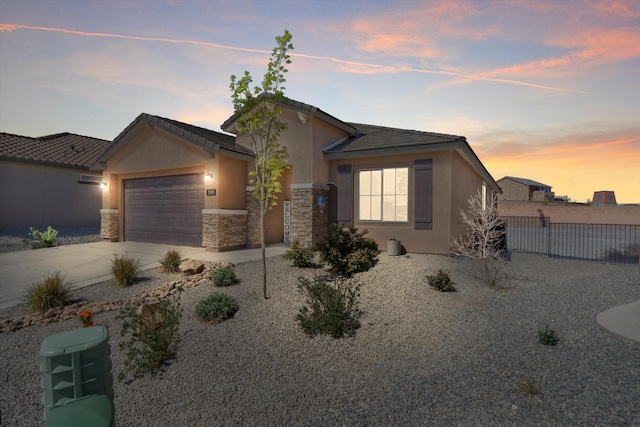 3003 Turquesa SE, Rio Rancho, NM 87124 - view of front facade featuring stucco siding, a garage, concrete driveway, and stone siding