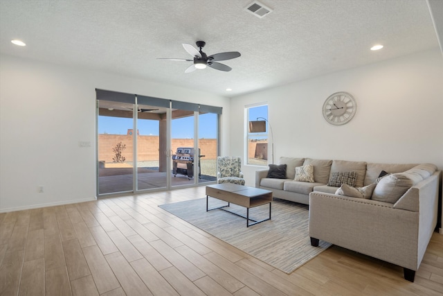 3003 Turquesa SE, Rio Rancho, NM 87124 - living area with healthy amount of natural light, ceiling fan, wood finished floors, a textured ceiling, and recessed lighting
