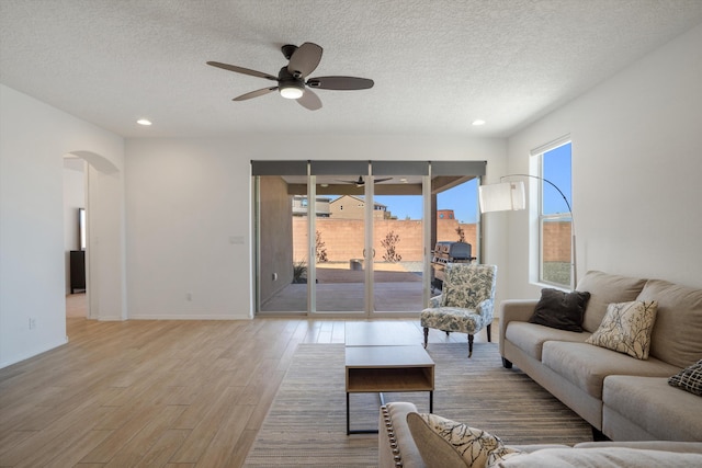 3003 Turquesa SE, Rio Rancho, NM 87124 - living room featuring ceiling fan, arched walkways, light wood finished floors, a textured ceiling, and recessed lighting