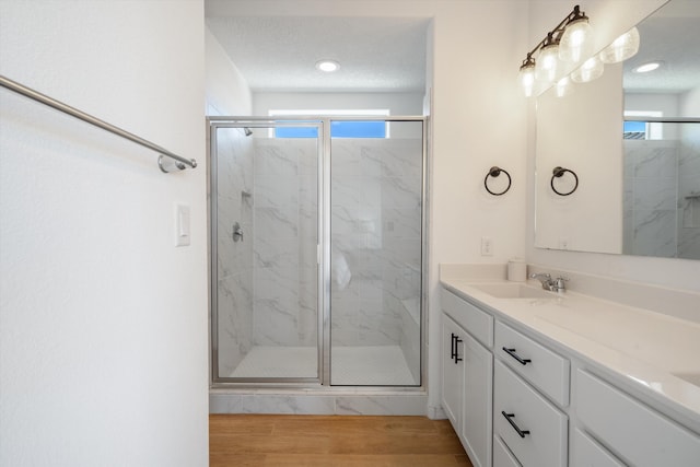 3003 Turquesa SE, Rio Rancho, NM 87124 - full bathroom with a marble finish shower, vanity, healthy amount of natural light, and wood finished floors