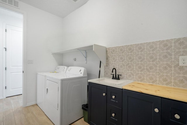 3003 Turquesa SE, Rio Rancho, NM 87124 - laundry room featuring cabinet space, separate washer and dryer, and light wood finished floors
