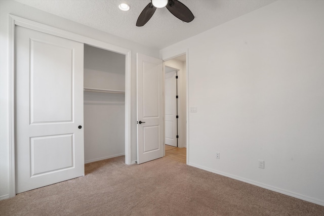 3003 Turquesa SE, Rio Rancho, NM 87124 - unfurnished bedroom featuring light carpet, baseboards, a closet, a textured ceiling, and a ceiling fan