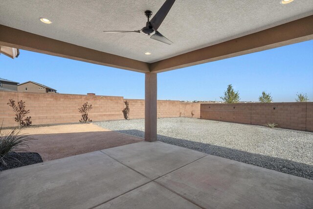 3003 Turquesa SE, Rio Rancho, NM 87124 - fenced backyard with ceiling fan and a patio