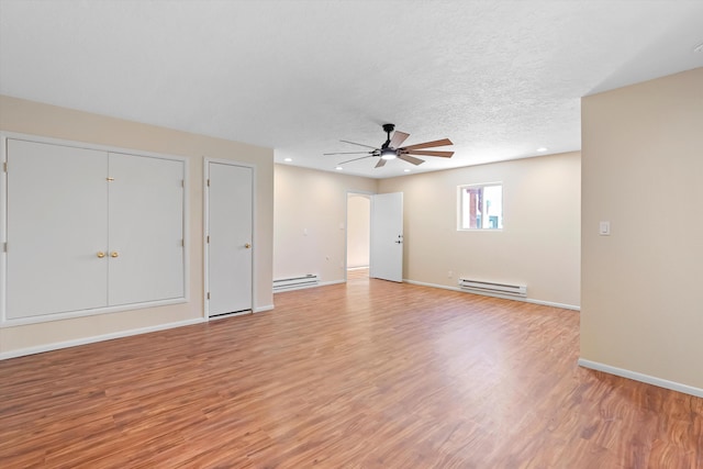 unfurnished living room with a baseboard radiator, light wood-style flooring, ceiling fan, and baseboard heating