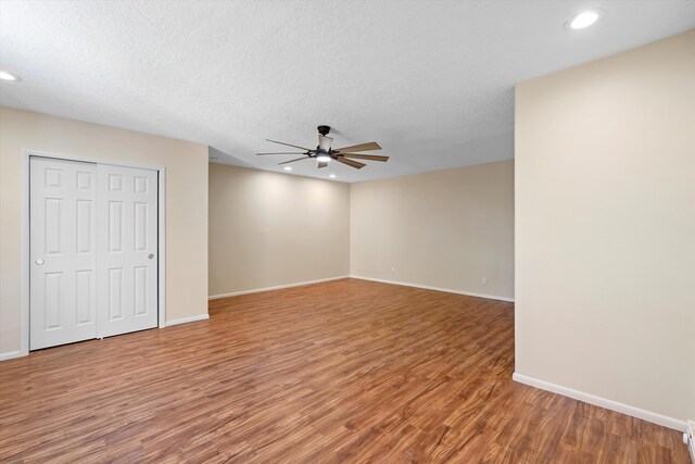 empty room featuring baseboards, ceiling fan, recessed lighting, and wood finished floors
