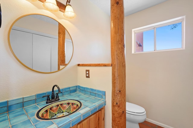 half bathroom featuring toilet and vanity