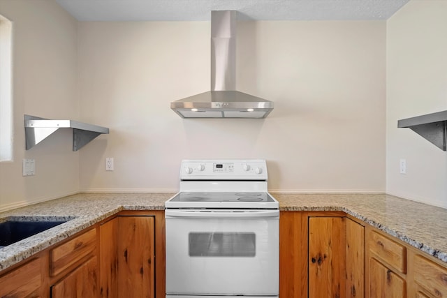 kitchen featuring light stone counters, white range with electric cooktop, brown cabinets, and wall chimney exhaust hood