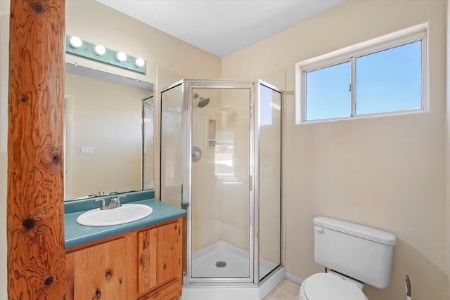 full bathroom with vanity, tile patterned flooring, a stall shower, and toilet