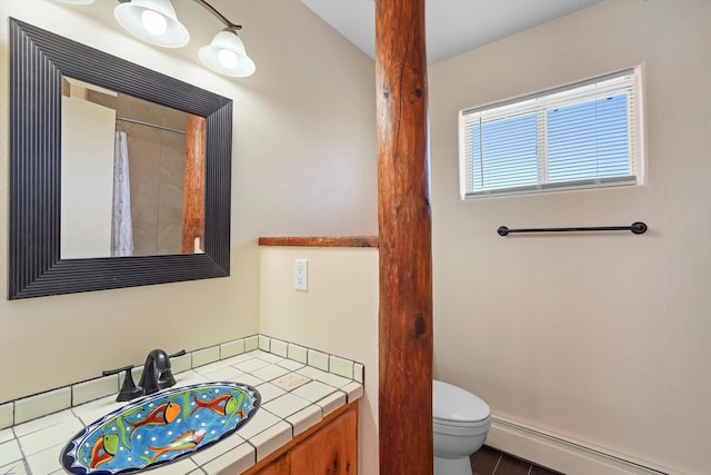 bathroom featuring vanity, toilet, and a baseboard radiator