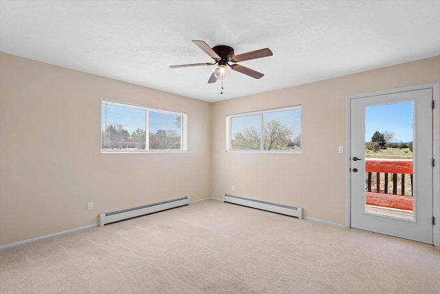 empty room with baseboards, baseboard heating, a ceiling fan, and light carpet