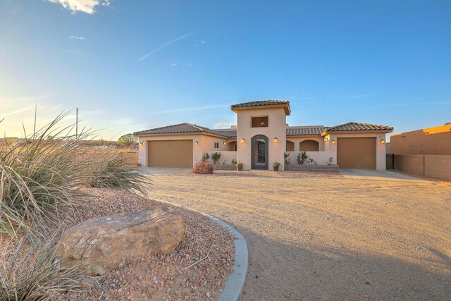 1797 Vargas Rd SE, Rio Rancho, NM 87124 - mediterranean / spanish house featuring a garage, concrete driveway, and stucco siding