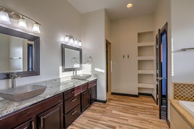 1797 Vargas Rd SE, Rio Rancho, NM 87124 - full bathroom with double vanity, wood finished floors, and tiled bath