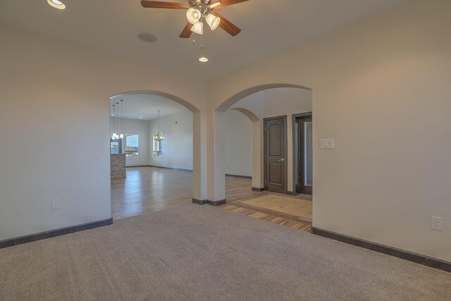 1797 Vargas Rd SE, Rio Rancho, NM 87124 - unfurnished room with carpet flooring, a ceiling fan, arched walkways, recessed lighting, and wood finished floors