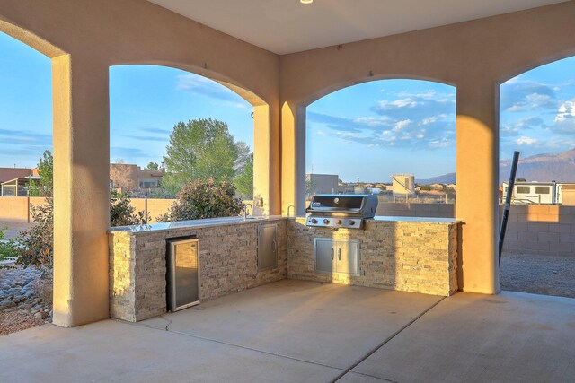 1797 Vargas Rd SE, Rio Rancho, NM 87124 - mediterranean / spanish home with concrete driveway, an attached garage, a tile roof, and stucco siding
