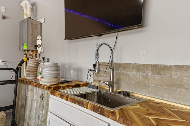 9109 Retablo Rd NW, Albuquerque, NM 87120 - kitchen with wood counters, white cabinets, and a sink