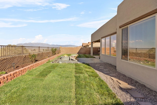 9109 Retablo Rd NW, Albuquerque, NM 87120 - view of yard with a patio area, a fenced backyard, and a mountain view