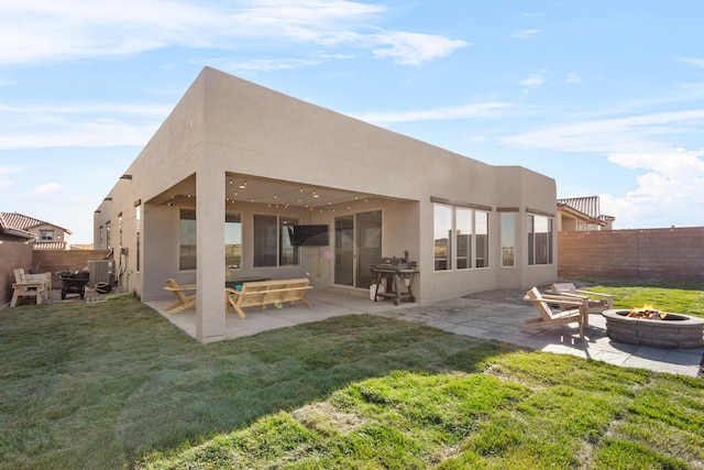 9109 Retablo Rd NW, Albuquerque, NM 87120 - rear view of property featuring stucco siding, a yard, a fenced backyard, and an outdoor fire pit