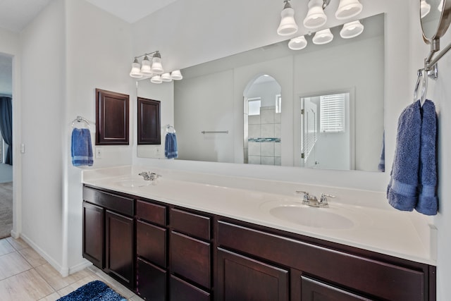 9109 Retablo Rd NW, Albuquerque, NM 87120 - bathroom with tile patterned floors, a sink, double vanity, and a tile shower