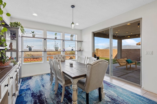 9109 Retablo Rd NW, Albuquerque, NM 87120 - dining space with baseboards, a textured ceiling, and recessed lighting