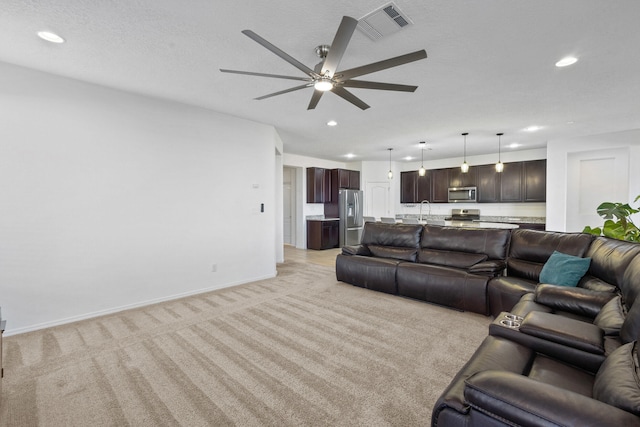 9109 Retablo Rd NW, Albuquerque, NM 87120 - living room with recessed lighting, visible vents, a ceiling fan, and light colored carpet