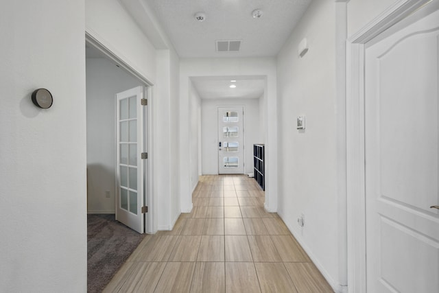 9109 Retablo Rd NW, Albuquerque, NM 87120 - hall featuring baseboards, visible vents, and light tile patterned floors