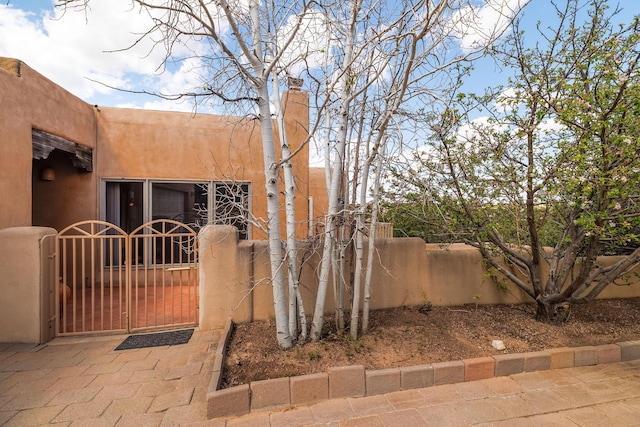 view of side of property with a gate and fence private yard