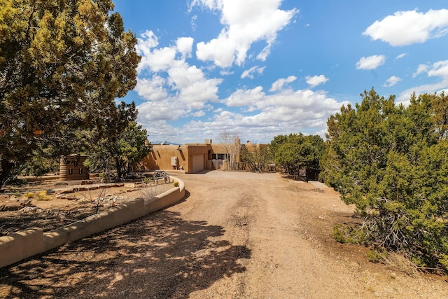 view of street featuring dirt driveway