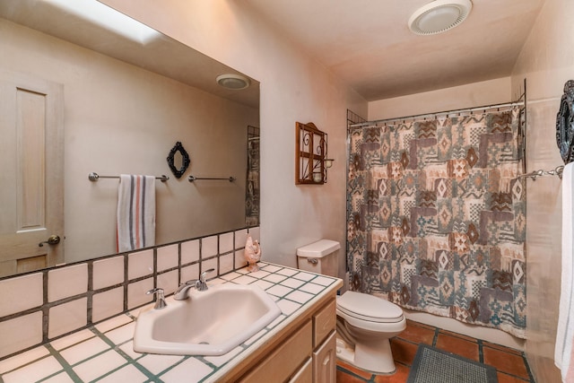 full bathroom with toilet, vanity, and tile patterned floors
