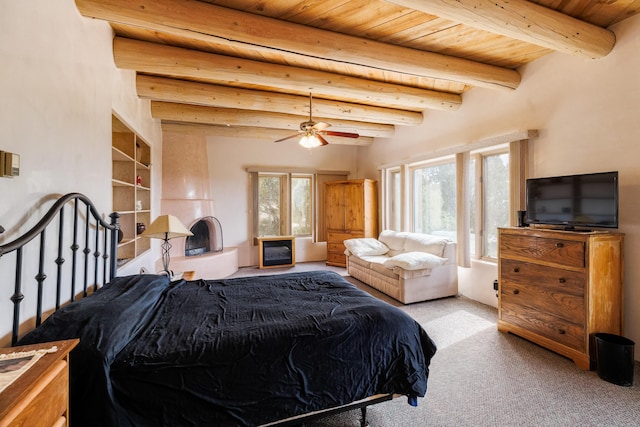 bedroom with carpet floors, beam ceiling, wooden ceiling, and multiple windows
