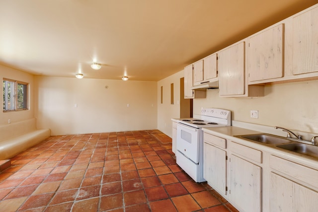 kitchen featuring under cabinet range hood, a sink, light countertops, and white electric range
