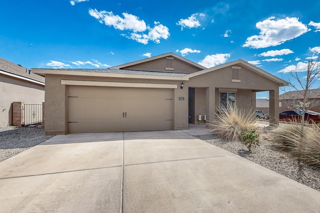 ranch-style home featuring an attached garage, stucco siding, and driveway