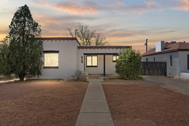 view of front of property with stucco siding and fence