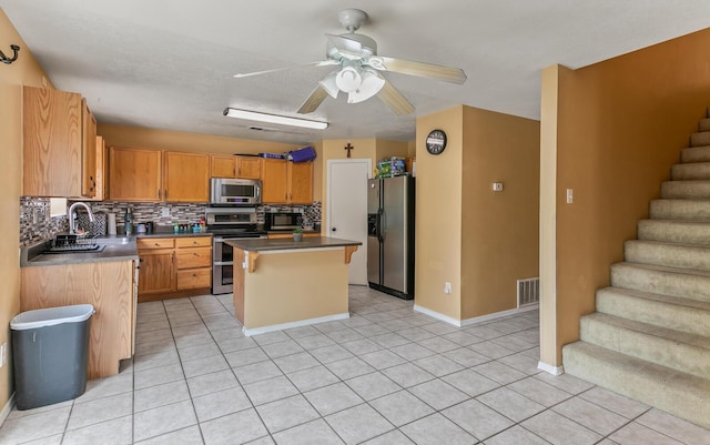 7419 Tolleson Ave NW, Albuquerque, NM 87114 - kitchen with tasteful backsplash, a sink, stainless steel appliances, visible vents, and a kitchen island