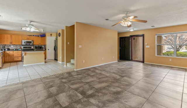 7419 Tolleson Ave NW, Albuquerque, NM 87114 - unfurnished living room with a ceiling fan, baseboards, and light tile patterned floors