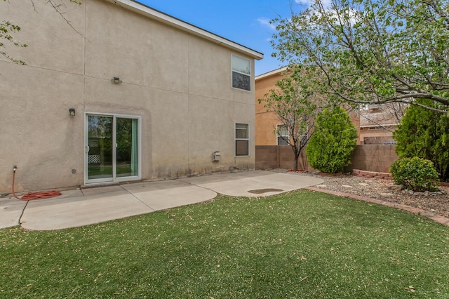 7419 Tolleson Ave NW, Albuquerque, NM 87114 - back of property featuring a patio area, a lawn, fence private yard, and stucco siding