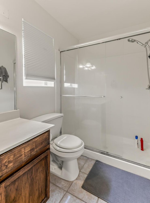 7419 Tolleson Ave NW, Albuquerque, NM 87114 - full bathroom featuring a shower stall, toilet, vanity, and tile patterned flooring