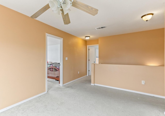 7419 Tolleson Ave NW, Albuquerque, NM 87114 - spare room with light carpet, baseboards, visible vents, and a ceiling fan