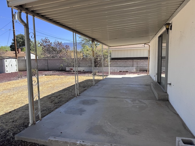 6329 Prairie Rd NE, Albuquerque, NM 87109 - view of patio with a fenced backyard, a shed, and an attached carport