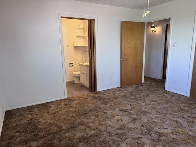 6329 Prairie Rd NE, Albuquerque, NM 87109 - unfurnished bedroom featuring carpet floors, a textured ceiling, baseboards, and connected bathroom