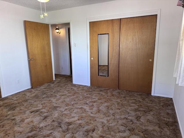 6329 Prairie Rd NE, Albuquerque, NM 87109 - unfurnished bedroom featuring carpet, a closet, and a textured ceiling