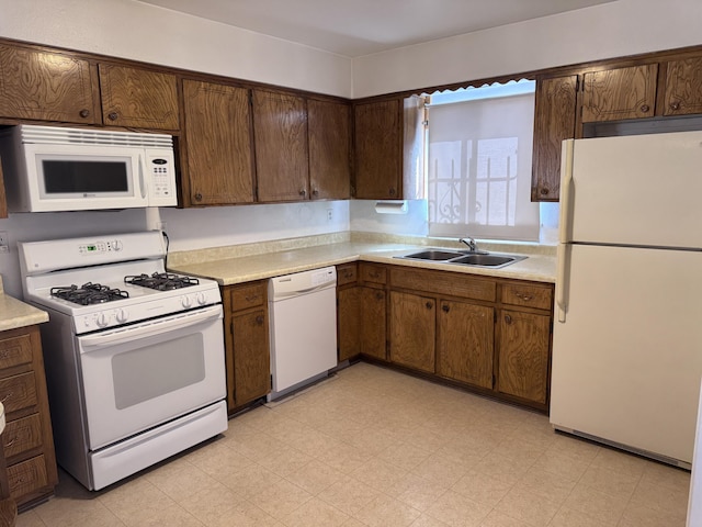 6329 Prairie Rd NE, Albuquerque, NM 87109 - kitchen with a sink, light floors, white appliances, and light countertops