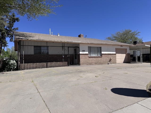 6329 Prairie Rd NE, Albuquerque, NM 87109 - ranch-style house with brick siding, an attached garage, a chimney, and concrete driveway