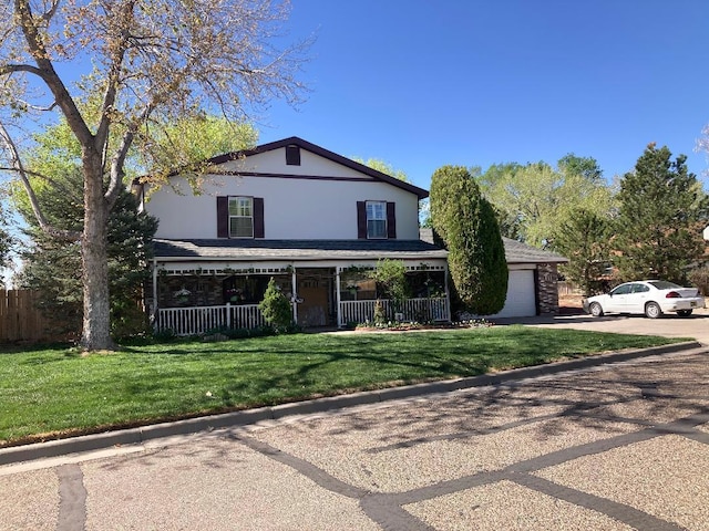 view of front facade with covered porch, a front yard, a garage, concrete driveway, and stucco siding
