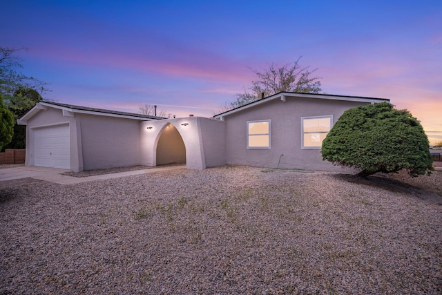 ranch-style house with stucco siding and a garage