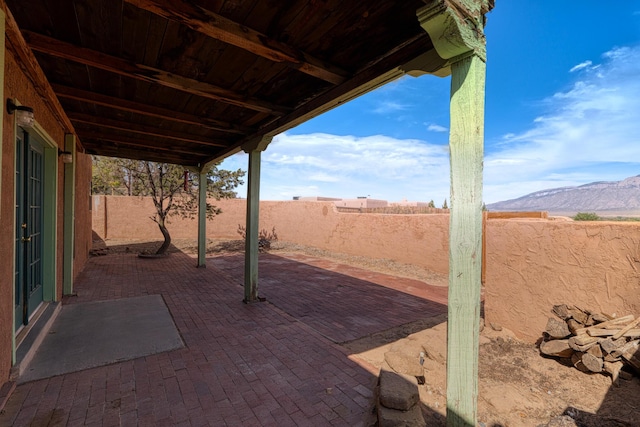 view of patio featuring a mountain view and a fenced backyard