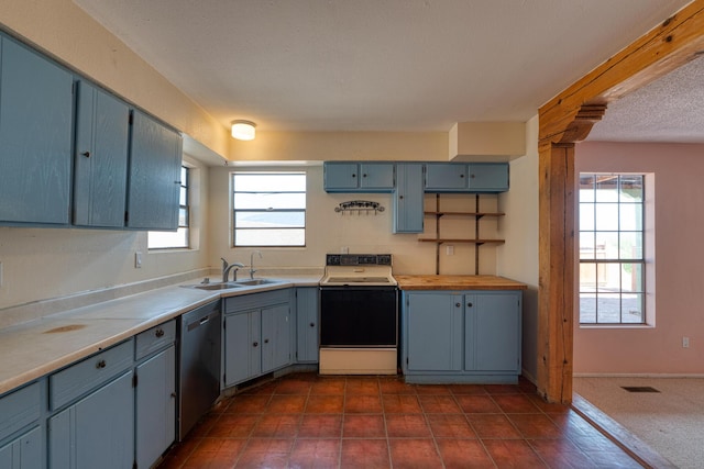 kitchen featuring range with electric stovetop, stainless steel dishwasher, a sink, light countertops, and blue cabinets