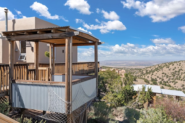 wooden deck with a mountain view