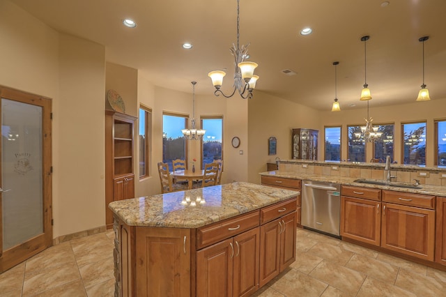 255 Diamond Tail Rd, Placitas, NM 87043 - kitchen featuring a chandelier, stainless steel dishwasher, brown cabinets, a center island, and light stone counters
