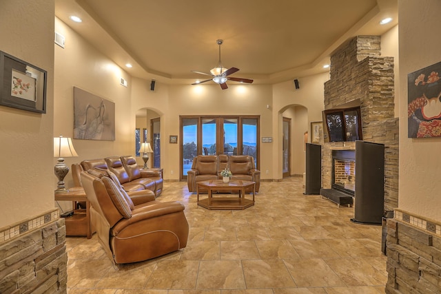 255 Diamond Tail Rd, Placitas, NM 87043 - living room with arched walkways, ceiling fan, recessed lighting, a fireplace, and a towering ceiling